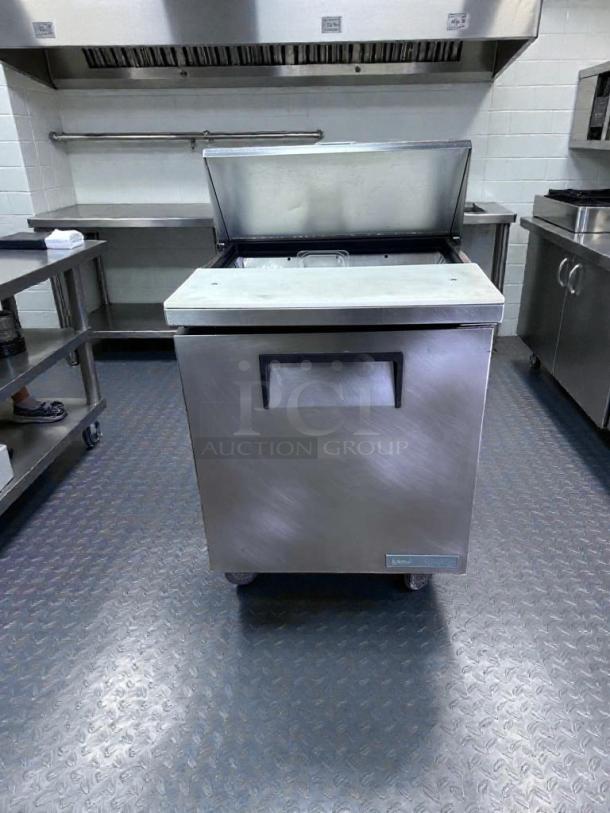 True TSSU-27-08-HC prep table in exceptional condition, open lid, stainless steel, on wheels, fully tested and working.