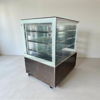 Immaculate Commercial Refrigerated Glass Display Case, 115V/Single Phase, tested and working. Four glass shelves, on wheels.