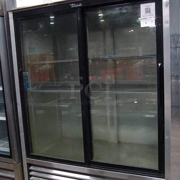 True 1/10" reach-in refrigerator, two sliding glass doors, shelves visible, model 115v, in used condition.