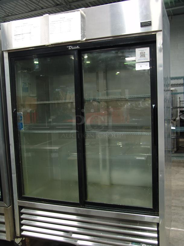 True 1/10" reach-in refrigerator, two sliding glass doors, 115v, stainless steel, visible internal shelving, used condition.