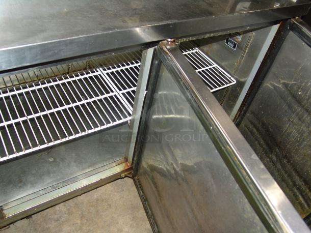 Kelvinator 24 cu. ft. pizza prep table, model KCPT92.12, stainless steel, open doors showing shelves, light wear visible.