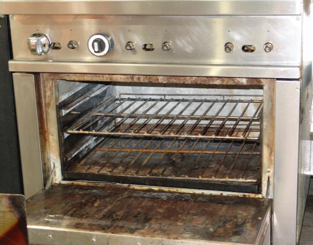 Patriot PT-R36 6-burner natural gas range, stainless steel, 36" wide. Features control knobs, interior racks, visible wear.