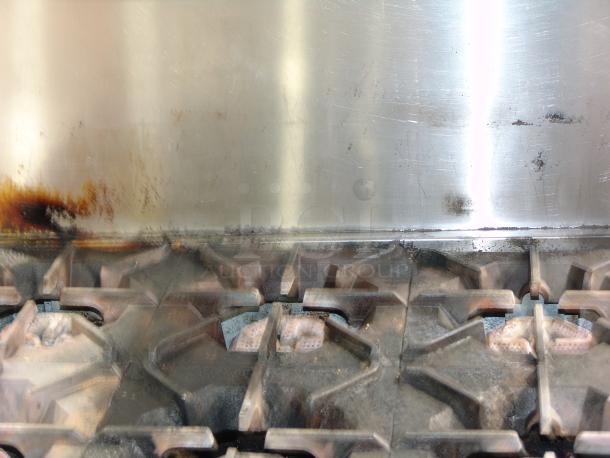 Patriot PT-R36 6-burner natural gas range, heavily used, with visible surface stains and wear marks, stainless steel finish.