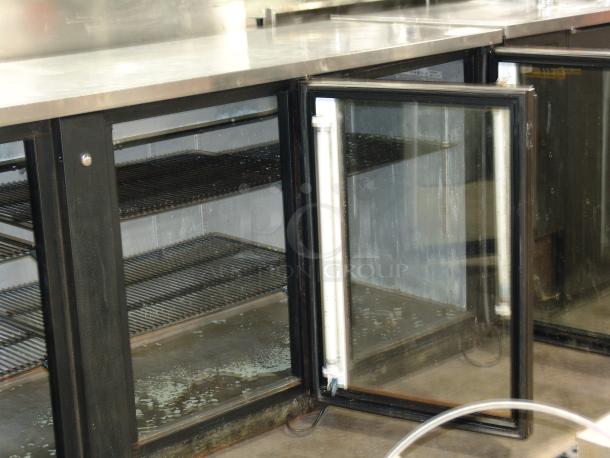 True TBB-4G 3/8" bar refrigerator, 3 glass doors, black, 115v, exceptional condition, brand label visible inside.