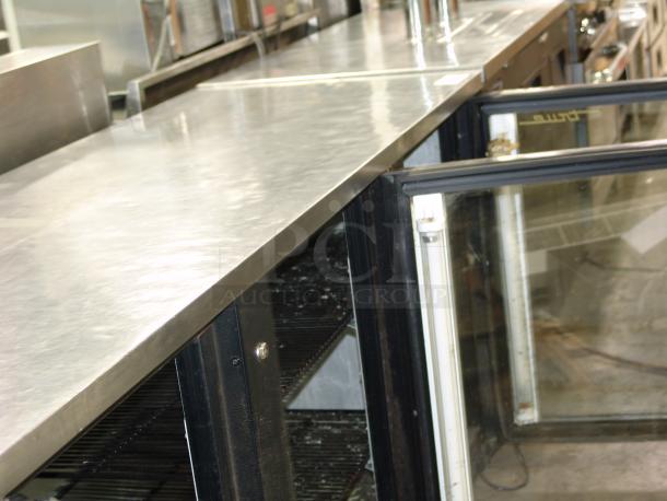 Alt text: True TBB-4G bar refrigerator, black, with 3 glass doors open, 115v, in exceptional condition, model TDD-2.