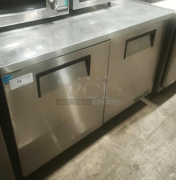 True TUC-48 undercounter commercial refrigerator, stainless steel, dual-door, heavy-duty, visible label indicating model.