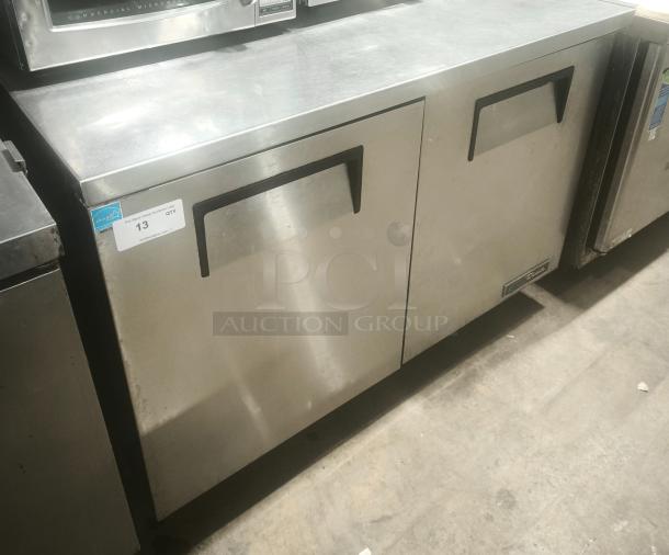 True TUC-48 undercounter commercial refrigerator, stainless steel, dual doors, heavy duty, labeled with auction tag #13.