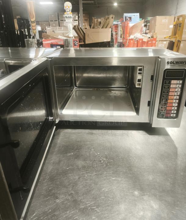 Solwave EM025FJT-S0SA00 stainless steel commercial microwave, 120V, 1000W, with push button controls, open door, used condition.