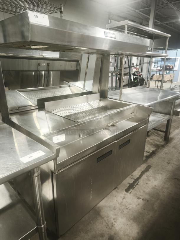 Delfield commercial refrigerator sandwich prep table, stainless steel, used condition, with shelving and label on front.