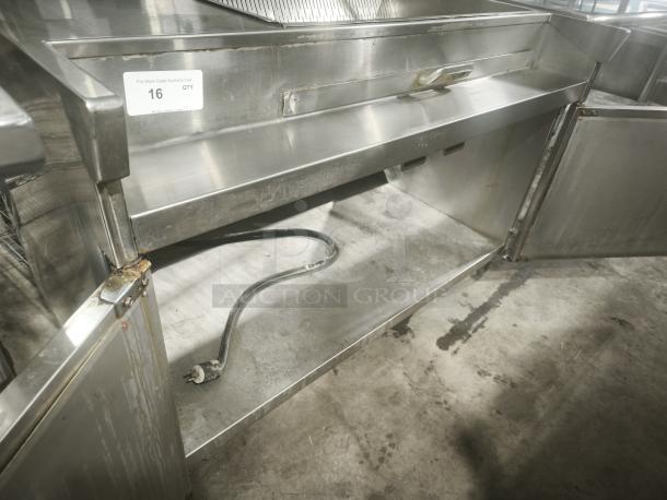Delfield commercial refrigerator sandwich prep table, stainless steel, visible wear, open storage, plug visible, label marked QTY 16.