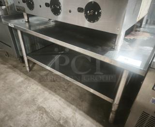 Stainless Steel Commercial Worktable with 4" Backsplash, adjustable feet, and metal construction, ideal for food prep. Premium condition.