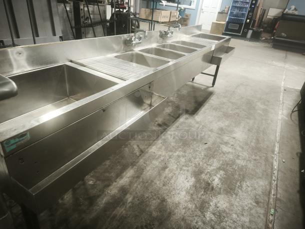 Stainless steel 4-bay bar sink in premium condition, featuring a durable, sleek design ideal for commercial use.