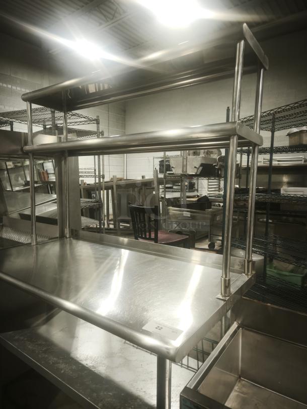 Stainless worktable with wide double-tier overshelf, in great condition. Ideal for kitchen prep. Metal build.