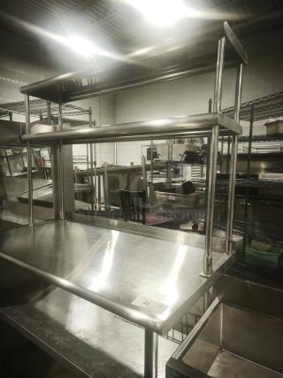 Stainless worktable with wide double-tier overshelf, in great condition. Ideal for kitchen prep. Metal build.