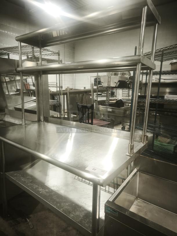 Stainless steel worktable with wide double-tier overshelf, great condition. Ideal for kitchen prep, durable metal construction.