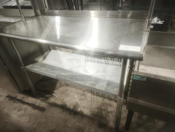Stainless worktable with wide double tier overshelf, in great condition. Metal kitchen prep table with shelving. Visible label: "22".