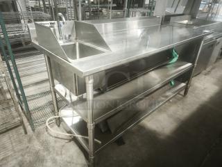 Commercial stainless steel prep table with sink, double undershelf; excellent condition, integrated faucet, durable design.