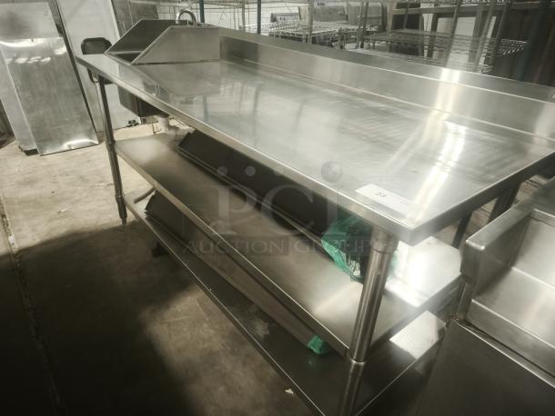 Commercial stainless steel prep table with sink, double undershelf; excellent condition, sturdy design, versatile for kitchens.