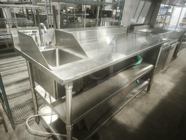 Commercial stainless steel prep table with sink and double undershelf; in excellent condition; ideal for kitchens.
