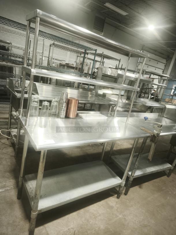 Stainless steel work table with wide double-tier overshelf, excellent condition, ideal for kitchen prep, visible sturdy construction.