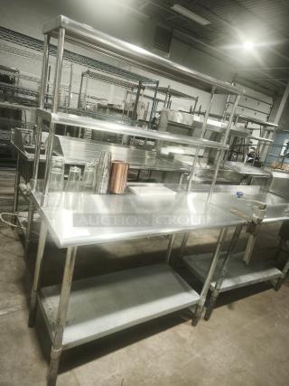 Stainless steel work table with wide double-tier overshelf, excellent condition, ideal for kitchen prep, visible sturdy construction.