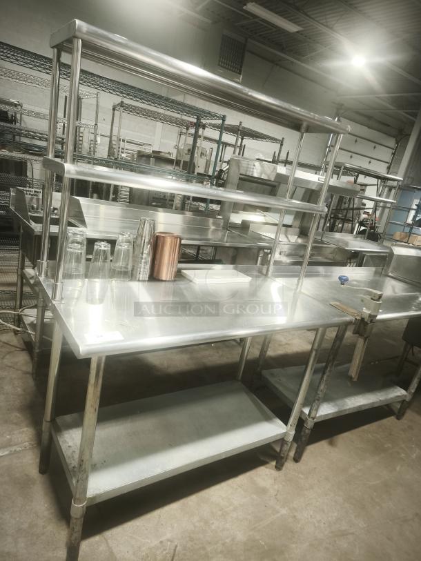 Stainless steel work table with wide double-tier overshelf, excellent condition, ideal for kitchen prep and storage.