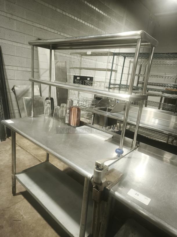 Stainless steel work table with wide double tier overshelf, excellent condition, features metal kitchen prep table and shelving combo.