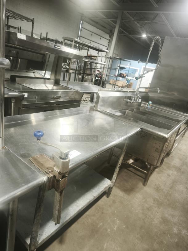 Heavy duty stainless steel worktable with manual table-mounted can opener, industrial-grade, good condition.