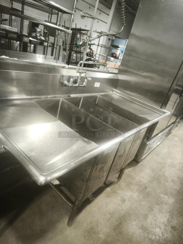 Heavy duty stainless steel 3-compartment butcher sink, excellent condition, industrial faucet, sturdy legs, ideal for commercial use.