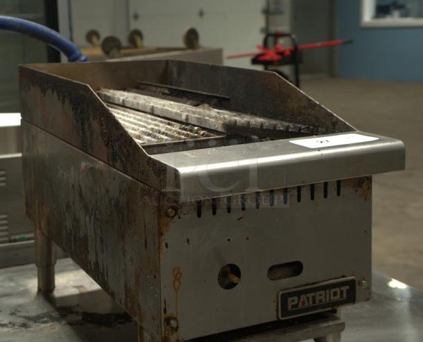 Patriot PT-CB12-M gas radiant charbroiler, 12" wide, stainless steel, visible wear, model label present.