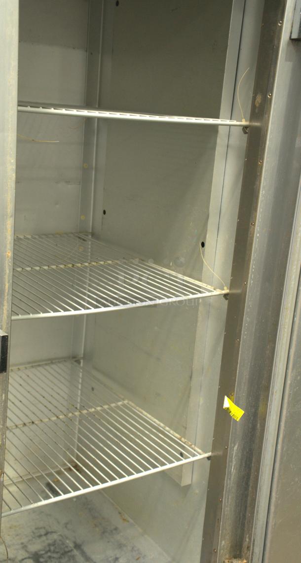 Traulsen G12010 reach-in freezer with right hinge solid door, three shelves, great condition, 115v, interior view.