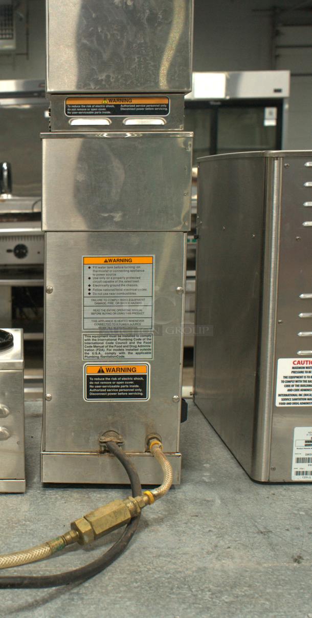BUNN VP17-2 SS Brewer in premium condition. Stainless steel body, visible warning labels, and connected hoses. Ideal for high-volume brewing.