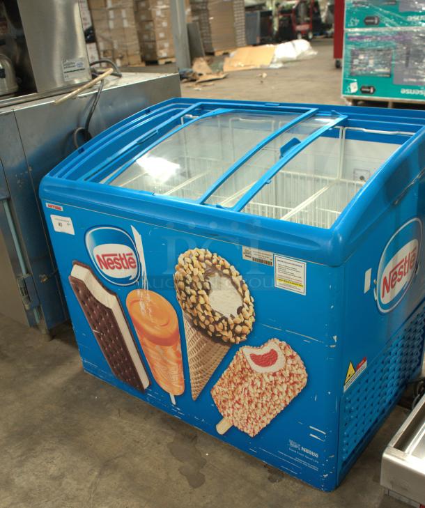 AHT RIO S 100 ice cream freezer in premium condition, sliding glass top, vibrant Nestlé branding, ideal for merchandising.