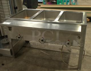Heavy duty natural gas hot food table with three wells, stainless steel, used condition. Ideal for catering or restaurants.
