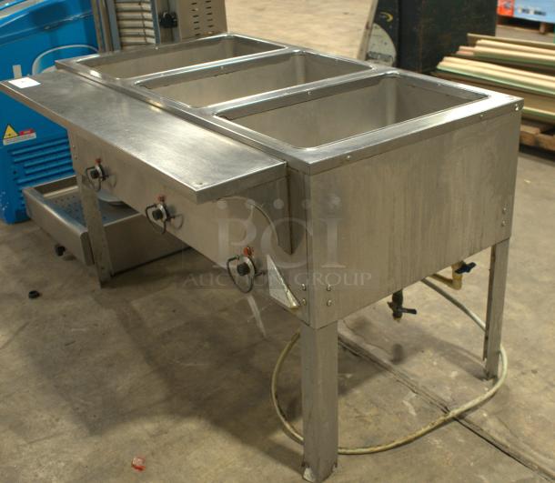 Heavy Duty Natural Gas Hot Food Table with 3 Wells; stainless steel; used; features adjustable controls and robust legs.