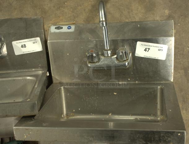 Stainless steel commercial hand washing sink, heavy-duty, NSF-certified, with dual handles. Item tagged "47" for auction.