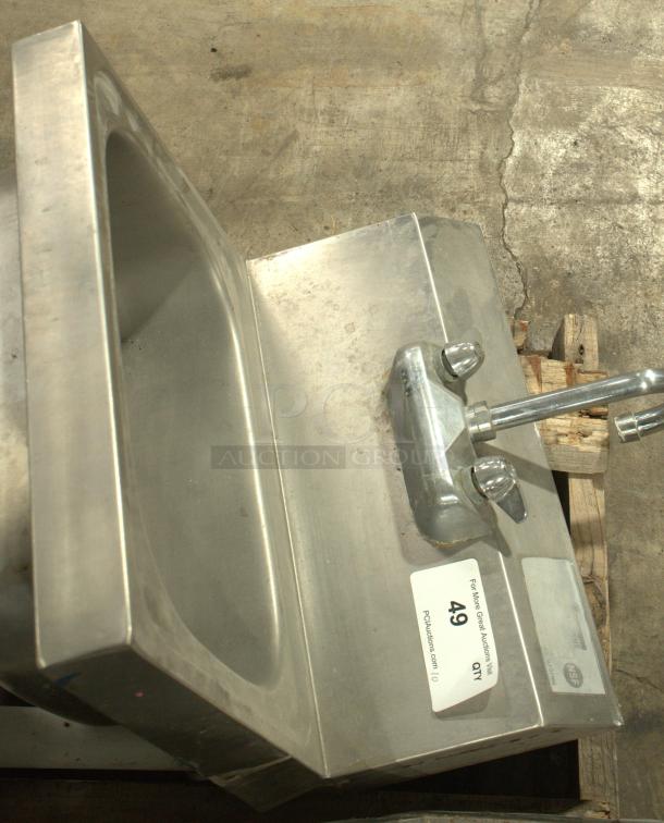 Stainless steel commercial hand washing sink in heavy-duty condition. Features faucet and labeled NSF certification. Ideal for industrial use.