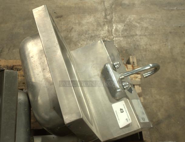 Stainless-steel commercial hand washing sink, heavy-duty, with faucet, mounted on pallets. Tag indicates auction ID 49.