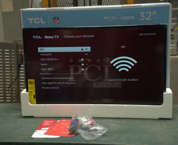 New TCL 32” Class S3 (32S331) 720p HD LED Smart TV with Roku TV, in box. Includes energy guide, remote, setup materials.