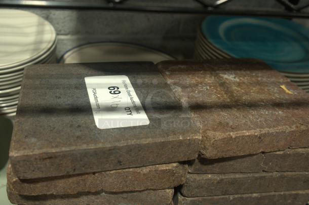 Heavy-duty volcanic granite slabs for cooking, NSF certified. Visible label with quantity: 69. Ideal for culinary use.