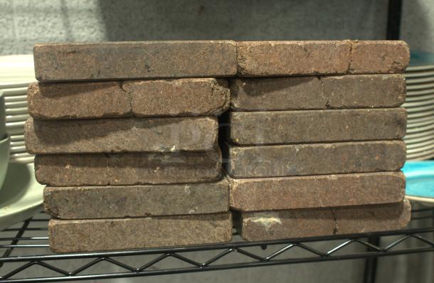 NSF Certified heavy-duty volcanic granite slabs for cooking, stacked, showing natural texture and robust condition.