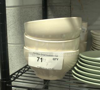 A stack of three white stoneware bowls on a shelf, each featuring a smooth finish. Label indicates auction details.