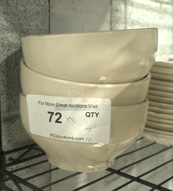 Stoneware bowls stacked on a shelf, beige color, smooth finish. Label reads "72 QTY x3" with auction site URL.