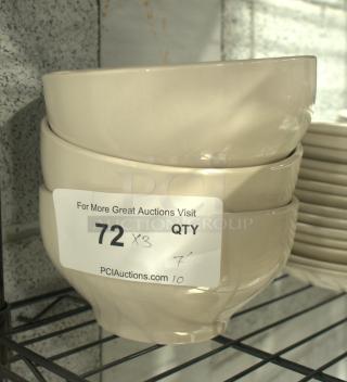 Stoneware bowls stacked on a shelf, beige color, smooth finish. Label reads "72 QTY x3" with auction site URL.