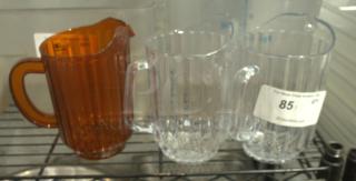 Heavy-duty break-resistant 60 oz plastic restaurant pitcher. Clear and amber colors, sturdy handle, ribbed design.