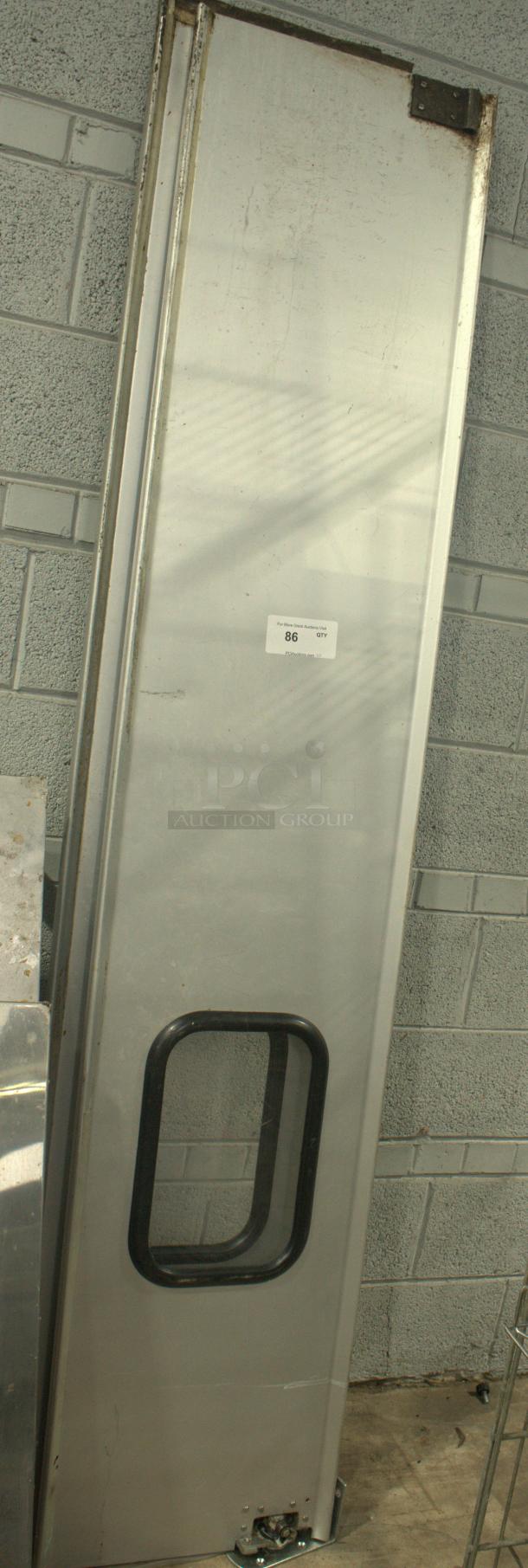 Heavy-duty aluminum swing door set, used condition, with lower window panel. Label indicates item number 86.