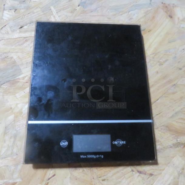 Digital kitchen scale, black, max 5000g ±1g. Features two buttons: "Unit" and "On/Tare." Good condition.