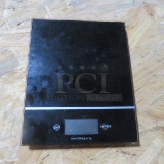 Digital kitchen scale, black, max 5000g ±1g. Features two buttons: "Unit" and "On/Tare." Good condition.