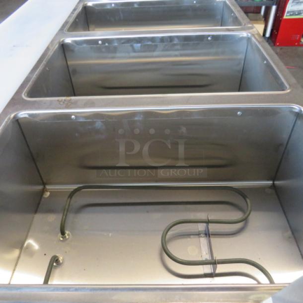 One NEW Servit 4 Well Electric Steam Table, Model 423EST4WO500, with sneeze guards, cutting board, SS under shelf, casters.