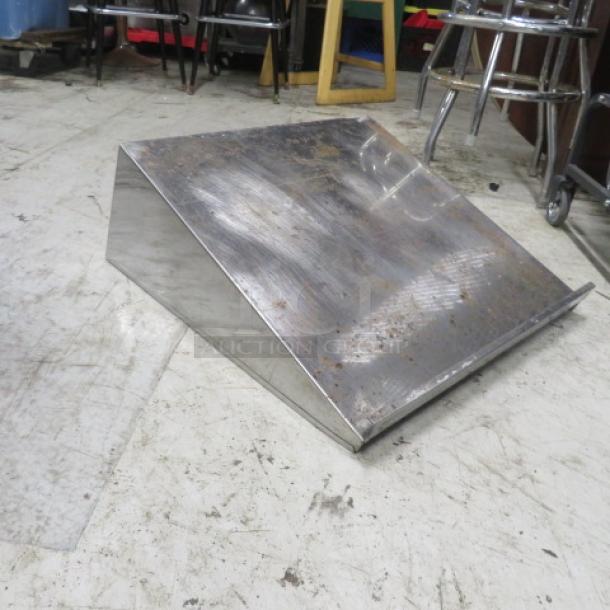 Advance Tabco stainless steel shelf, wall mount, 24x24x10 inches, shows signs of wear, slightly rusted surface.
